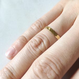 wide gold rings on ring finger