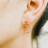 Rose gold hoop earring on ear