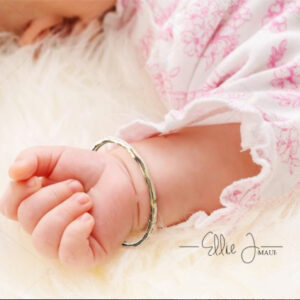 baby bangle on wrist in pink dress