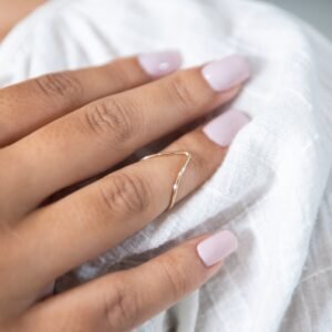 V midi ring on womans hand