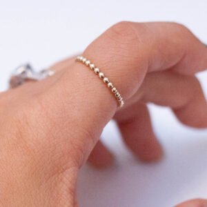 gold ball ring on finger